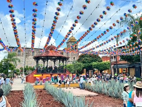 Colorful courtyard decorated with banners at the Jose Cuervo Express Premium Plus experience in Tequila, Mexico.