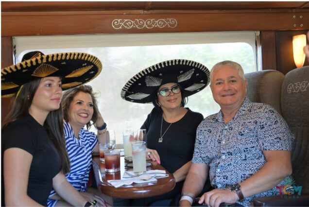 Group of guests wearing sombreros and enjoying drinks on the Jose Cuervo Express Train