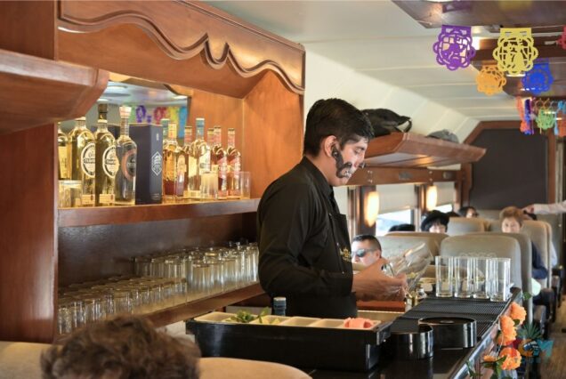 Bartender mixing drinks behind the bar on the Jose Cuervo Express Train