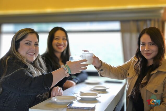 Three women inside the Tequila Express Train toasting drinks during the tequila train experience.