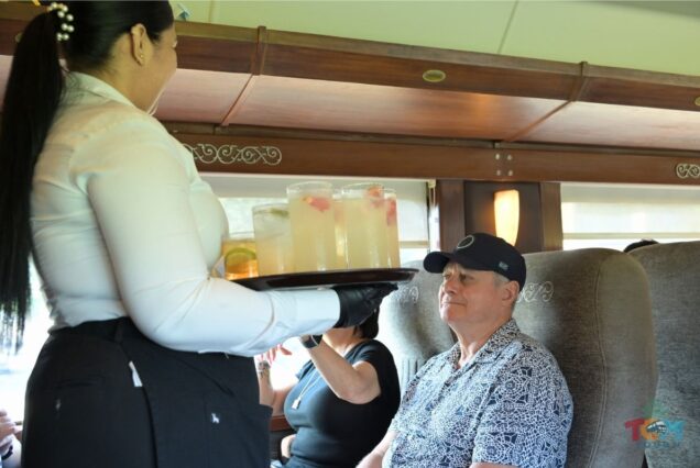 Server offering drinks to a guest aboard the Jose Cuervo Express Train