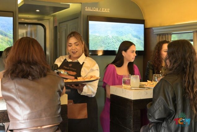 Staff member serving snacks inside the Tequila Express Train’s Vagon Bar during the tequila train ride.