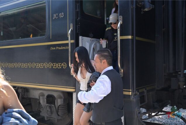 Passengers stepping off the Jose Cuervo Express Train with staff assistance