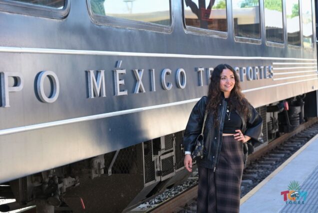 A woman smiling next to the Tequila Express train with Grupo México Transportes lettering.