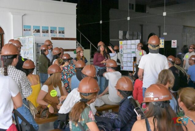 Casa Sauza visitors gather in a briefing area wearing helmets during the tequila train experience.