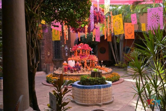 Day of the Dead altar decorated with marigolds and papel picado at Casa Sauza on the Tequila Express Train tour.