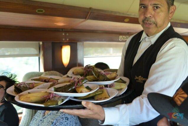 Server presenting plates of tamales aboard the Jose Cuervo Express Train